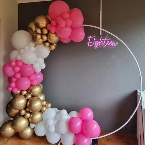 Circle hoop backdrop with a pink white gold balloon garland and eighteen neon in Redlands.