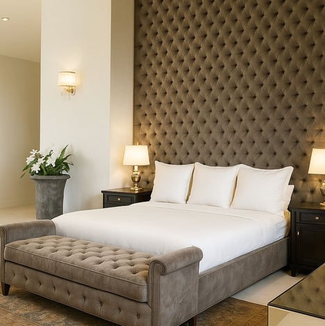 Tufted bed and bench with dark wall paneling, custom-designed by Solo Home Decor for a luxe bedroom.