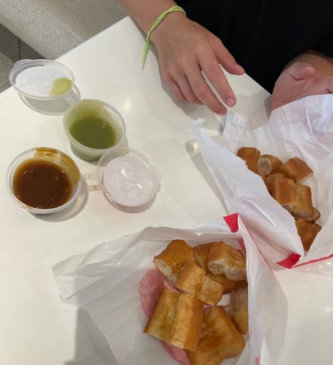 you tiao, a chinese snack. it's a fried dough with kaya and pandan dip on the side