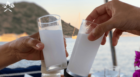 two people toasting Turkish Rakı glasses