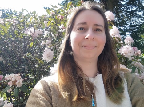 photo of author in front of flowering tree