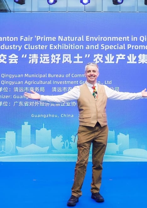 a man standing in front of a banner that says, the man is holding a