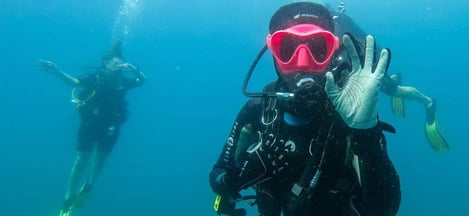 a person in a scuba suit and scuba goggles