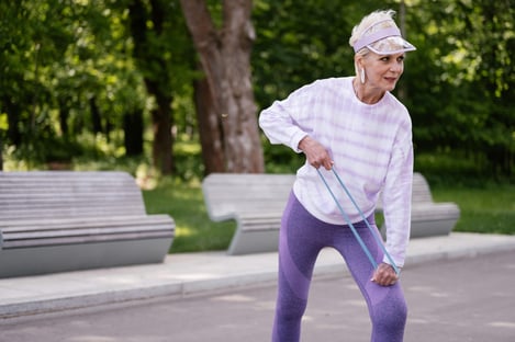 Women over 40 doing resistance band exercise for fat loss