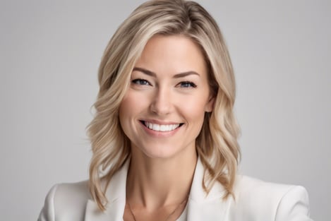 Business headshot of woman in white suit white backdround
