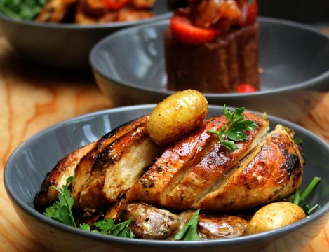Golden-brown, juicy air fryer chicken breast with a crispy crust, freshly cooked and resting.