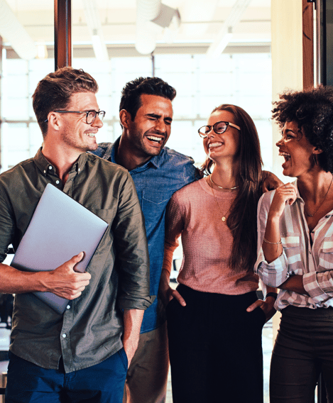 Two male and three female leaders gather in the office, all with happy expressions, as if they’re having a great time.