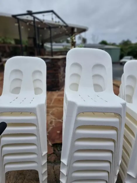 Stack of white plastic chairs at a private property in Mount Cotton, Redlands.