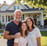 Smiling homeowner with family in front of remodeled house by Garnet Painting & Remodeling GA