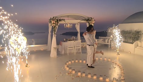 Memorable Santorini proposal marked by elegant stage fireworks under the stars.