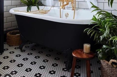 penny mosaic tiles under the tub in bathroom