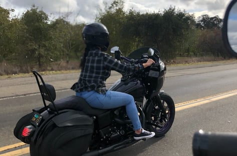woman riding black motorcycle