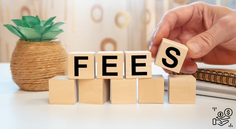 a person holding a wooden block with the word fees spelled in the letters