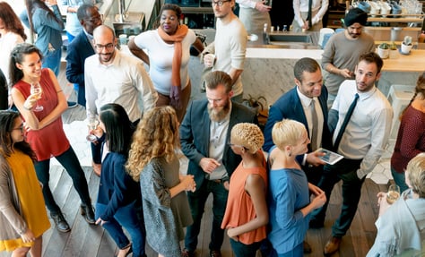 a group of people standing around a table