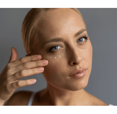 Woman applying eye cream to help prevent bags under eye and fine lines