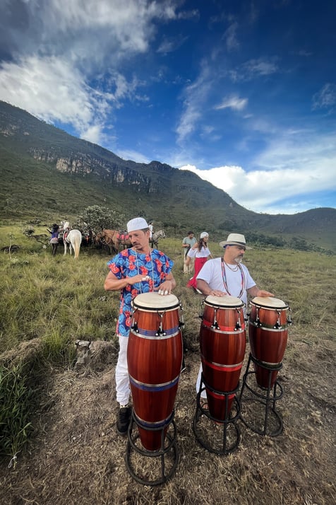 two men playing drums in a field
