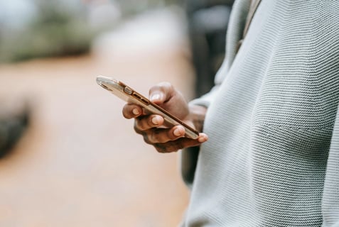 Hand holding a phone during an online video consultation with a veterinarian – ideal for pet owners