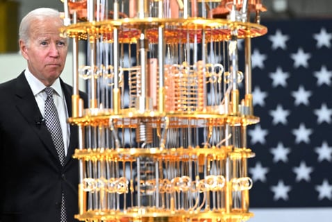 a man in a suit and tie is standing in front of a large model of