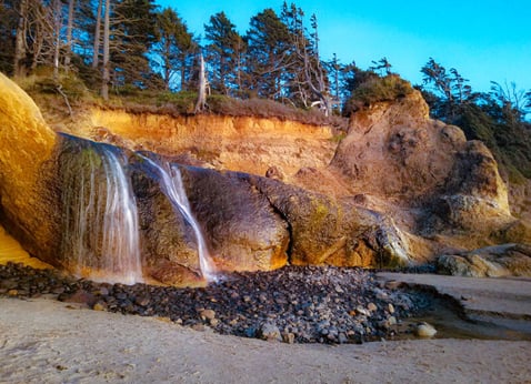 Oregon Coast - The waterfall coming down the cliffs at Hug Point State Rec site on the beach