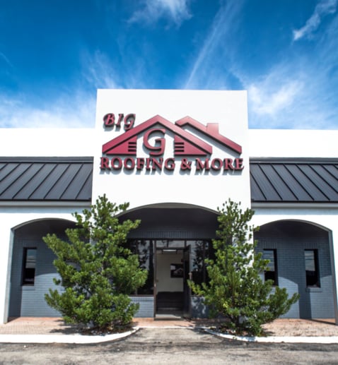 a building with a sign that says Big G Roofing 