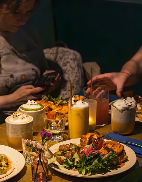 a table with plates of food and drinks