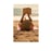 A woman on the beach lies on her back and reads a book