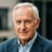Older man with gray hair in blazer outdoors. Trusted Cedar Rapids testimonial for tech handyman help.