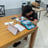 a boy is sitting at a table with a calculator