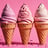 three ice cream cones with pink and white icing