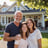 Smiling homeowner with family in front of remodeled house by Garnet Painting & Remodeling GA