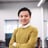 a man in a yellow sweater and a white shirt