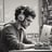 man sitting at computer with headphones on