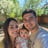 a man and woman taking a selfie with a baby