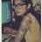 a woman with tattoos on her arm and a laptop