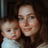 a woman holding a baby in her arms