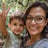 a woman holding a child and giving a peace sign