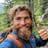 a man with a beard and a backpack on a trail