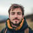 a man with a beard and a backpacker