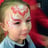 A Girl With Pink and Red Face Painting designs around her eyes