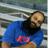 Man with blue shirt and beard smiling