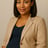 a pregnant woman in a tan blazer and black top