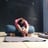 Restorative yoga pose to improve spinal flexibility with bolster and blanket as props