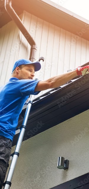a man is cleaning a gutter gutter gutter gutter gutter gut