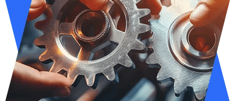 two hands holding gears and gears on a blue background