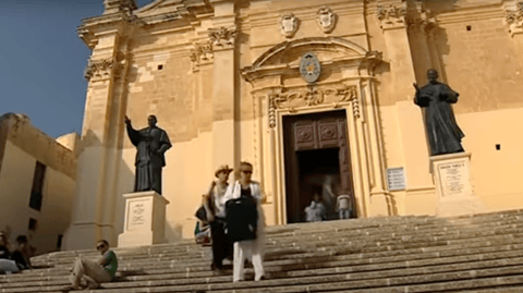 Steve and Eileen walk past the Cathedral on their hunt for a hotel.