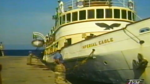 A boat moored next to a dock.