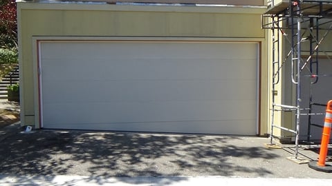 18x7 flush panel garage door with trailer.