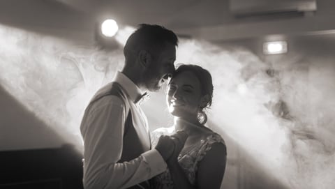 a man and woman standing in front of a smoke filled room