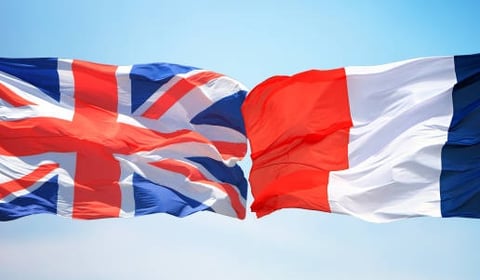 UK and France flags over maritime scene symbolizing international relation