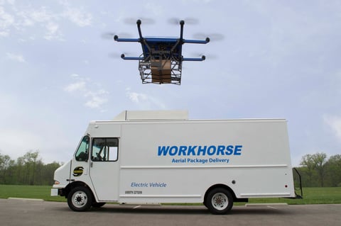 Drone delivering a package and a traditional delivery truck.